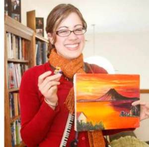 Covington’s Jillian Comrie is a piano teacher/vocal coach who is heading down to Ecuador to teach. Comrie poses Feb. 20 with souvenirs from her past trips to Ecuador.