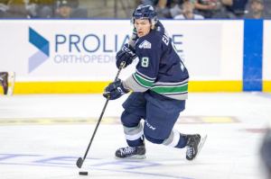 Thunderbirds captain Scott Eansor directs the puck up the ice during WHL play Tuesday night. Eansor scored Seattle’s lone goal in a 3-1 loss to Spokane at the ShoWare Center. COURTESY PHOTO