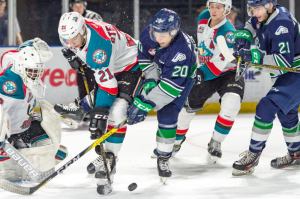 The Thunderbirds’ Zack Andrusiak (21) and the Rockets’ Devante Stephens (20) battle for the puck during WHL play Saturday night at the ShoWare Center. COURTESY PHOTO