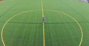 Kent parks planner Brian Levenhagen stands on the new synthetic turf at Wilson Playfields.