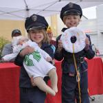 Lillia Smith, 6, and Isabelle Smith, 8, of Kent, completed their police officer costumes with help from their 2-month-old sister Cinthia, who was a cup of Starbucks coffee. HEIDI SANDERS, KENT REPORTER