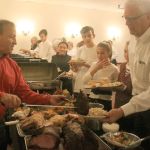 Jim Berrios, owner of the Golden Steer Steak &lsquo;n Rib House, serves up Thanksgiving meals to volunteers at the restaurant&rsquo;s annual community dinner on Nov. 24. Volunteers then went to work, serving 443 people who came for dinner. BRIAN BECKLEY, Reporter
