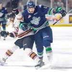 The Thunderbirds&rsquo; Alexander True, right, collides with a Calgary player during WHL play Friday night at the ShoWare Center. COURTESY PHOTO, Brian Liesse, Thunderbirds