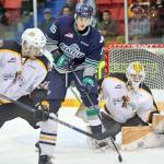 The Thunderbirds&rsquo; Alexander True and the Wheat Kings&rsquo; James Shearer battle for position in front of Brandon goalie Jordan Papirny. COURTESY PHOTO