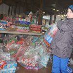 A boy helps carry a bag of donated toys inside Kent Lutheran Church for distribution. MARK KLAAS, Kent Reporter