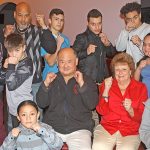 Glen and Leslie Hamada, center, with members of their boxing club, show fighting determination to make a difference in the community. MARK KLAAS,Kent Reporter