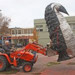 Greg Bartol, driving a small loader, carefully hoists and guides his strapped penguin sculpture into a new spot – at the corner of West Meeker Street and Second Avenue South. MARK KLAAS, Kent Reporter