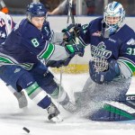 Thunderbirds captain Scott Eansor looks to clear the puck in front of goalie Rylan Toth during WHL play Saturday night at the ShoWare Center. COURTESY PHOTO, Brian Liesse/T-Birds
