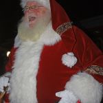 Santa Claus arrives by fire truck, greeting children and families during Winterfest at the Town Square Plaza on Saturday. MARK KLAAS, Kent Reporter