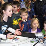 Danielle Idzi from the Ridgewood Elementary School Robotics Club shows kids moving Legos during the Tech Expo at the ShoWare Center on Thursday. RACHEL CIAMPI, Auburn Reporter