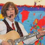 Nancy Stewart strums a number for her young audience. MARK KLAAS, Kent Reporter