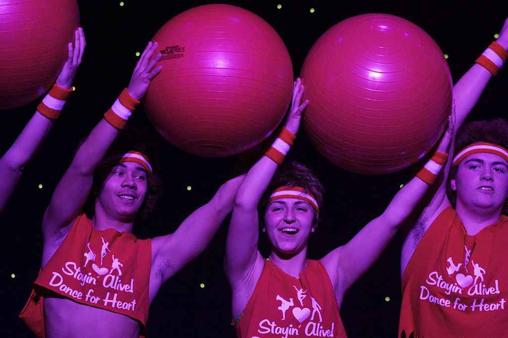 From left, Jameson Fujihara (as Richard Simmons), Samea Aljundi (Jane Fonda) and Jacob Battistoni (Simmons, too) &ldquo;Get Physical&rdquo; during a workout-dance performance on the Kentridge stage Friday night. MARK KLAAS, Kent Reporter