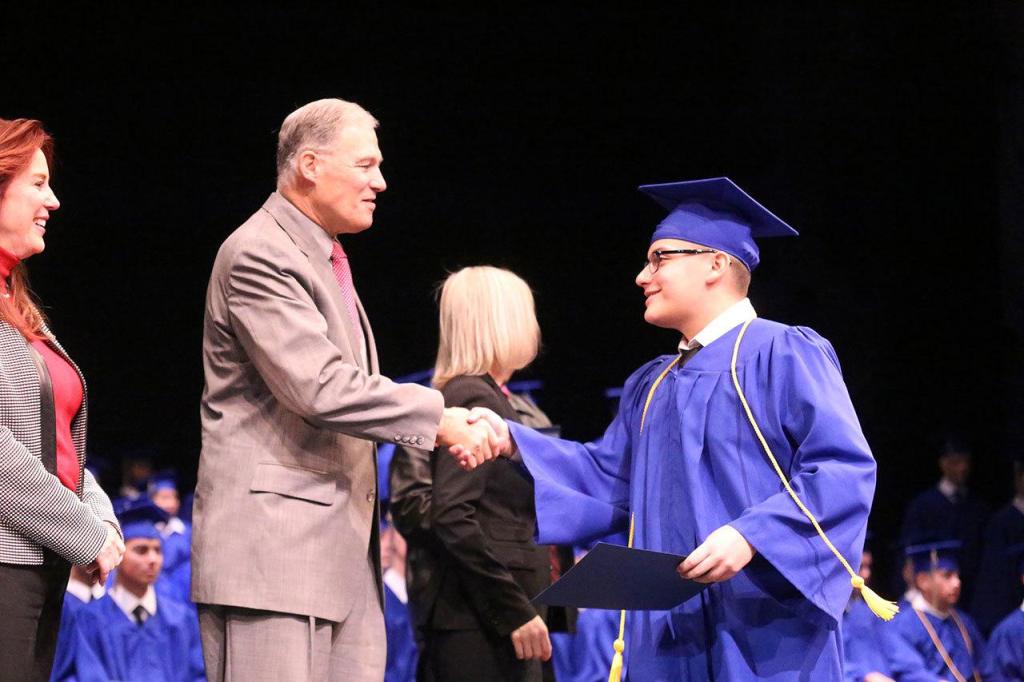 Kent&rsquo;s Jeovani Ontiveros Gomez, a cadet grad, shakes hands with Gov. Jay Inslee with Secretary of State Kim Wyman looking on. COURTESY PHOTO, Steven Friederich, Washington Youth Academy