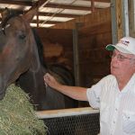 Hall of Fame trainer Jim Penney with one his geldings, Jebrica, in his stable in 2012. REPORTER FILE PHOTO