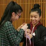 Cindy Tan and Khin Hoo, freshman at Kentridge, fingerweave during the Kent Kids&rsquo; Art Day. DENNIS BOX, Reporter