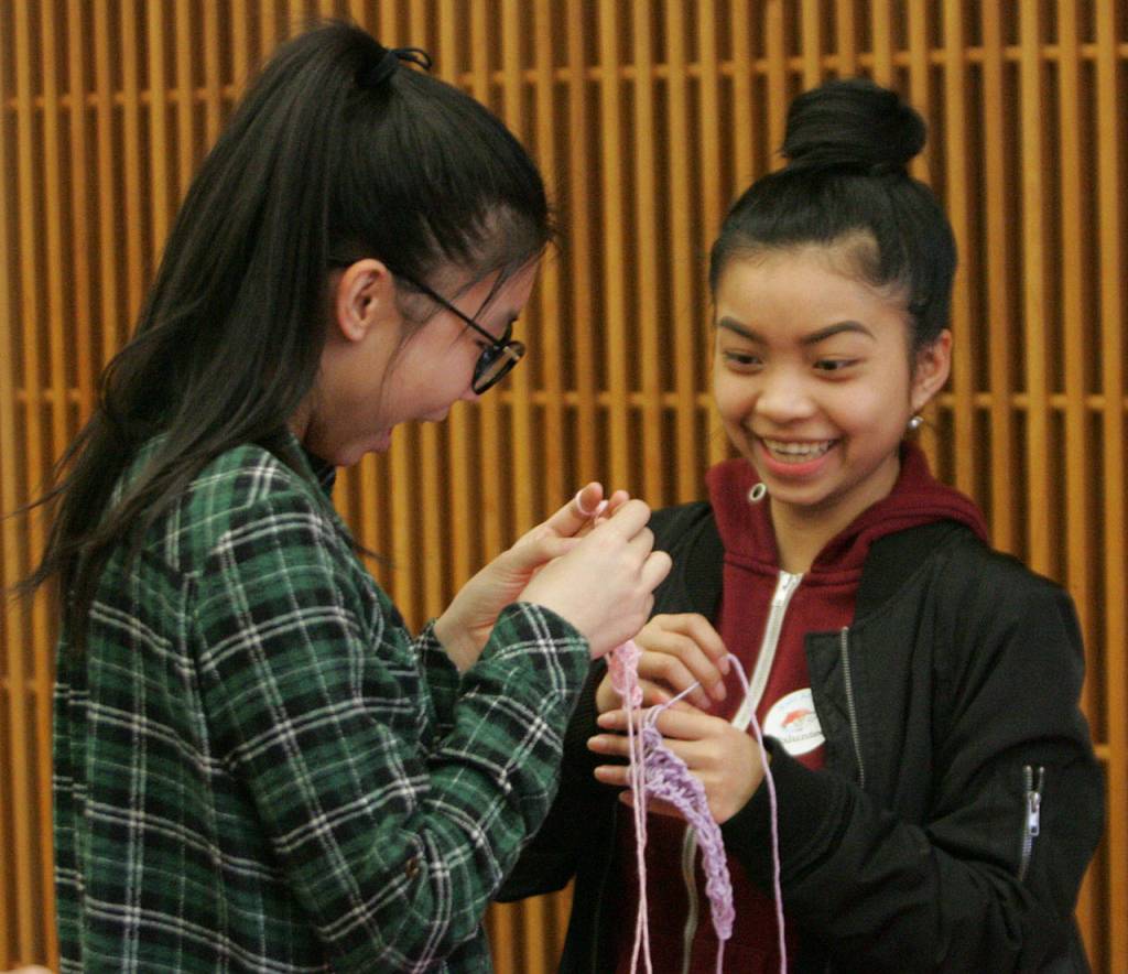 Cindy Tan and Khin Hoo, freshman at Kentridge, fingerweave during the Kent Kids&rsquo; Art Day. DENNIS BOX, Reporter