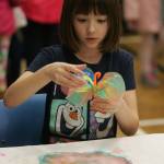 Aubrey Sidwell,7, an Emerald Park Elementary student, makes a butterfly during the Kent Kids&rsquo; Arts Day event. DENNIS BOX, Reporter