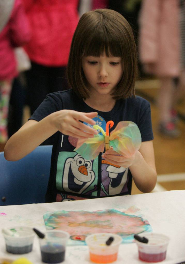Aubrey Sidwell,7, an Emerald Park Elementary student, makes a butterfly during the Kent Kids&rsquo; Arts Day event. DENNIS BOX, Reporter