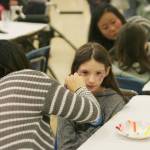 Aimee Phung, a Kent-Meridian High sophomore, paints 9-year-old Abigail Gonzalez&rsquo; face. Gonzalez is a student at Kent&rsquo;s Sunrise Elementary. DENNIS BOX, Reporter