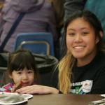 Abbey Quintos, Kentwood High senior Abbey Quintos stamps 2-year-old Molly Braaten&rsquo;s project. DENNIS BOX, Reporter