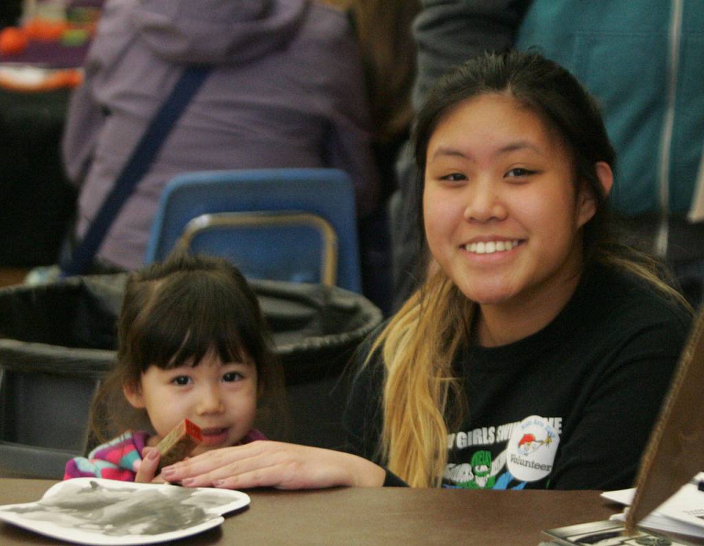 Abbey Quintos, Kentwood High senior Abbey Quintos stamps 2-year-old Molly Braaten&rsquo;s project. DENNIS BOX, Reporter