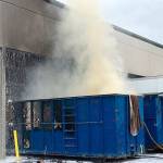 Kent firefighters extinguish dumpster fire next to commerical building