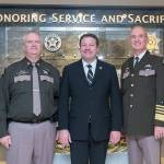 King County Councilmember Reagan Dunn, middle, joins Major Greg Thomas, left, and Sheriff John Urquhart, right, in front of the King County Sheriff&rsquo;s Officer Memorial. COURTESY PHOTO