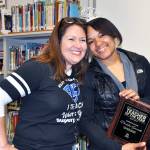 Kent Elementary Principal Rosa Villarreal, left, surprises sixth grade teacher Denisha Saucedo with a plaque naming her the Kent School District Teacher of the Year for 2017. COURTESY PHOTO, Kent School District