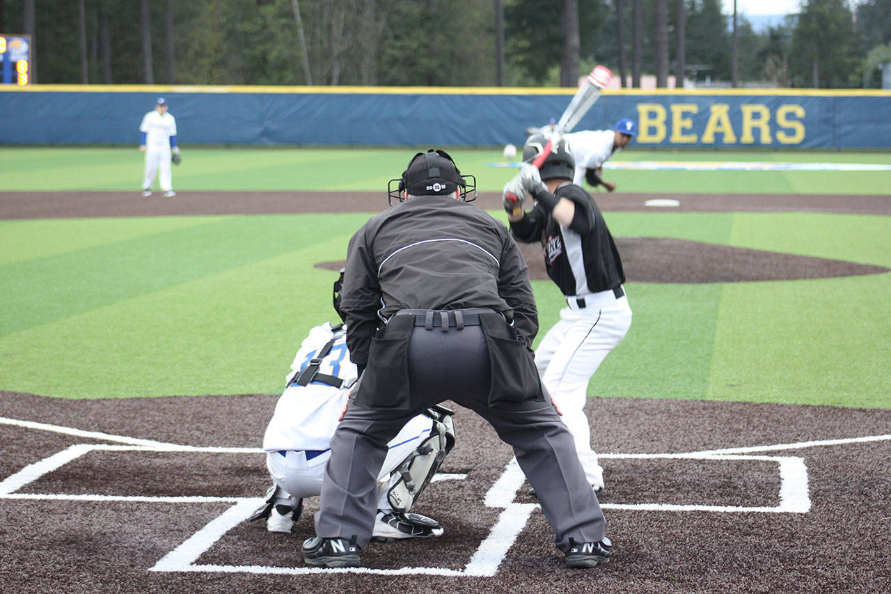Tahoma junior Josh Leonard throws a pitch to Kentlake senior Kyle Combs Wednesday at the new Tahoma High School. The Falcons won 7-3. SARAH BRENDEN, The Reporter