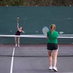 Kentlake&rsquo;s Hallie Fredericks serves as Kentwood&rsquo;s Sam Tate watches on. SARAH BRENDEN, The Reporter