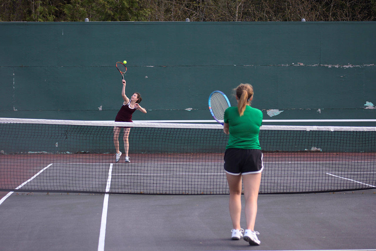 Kentlake&rsquo;s Hallie Fredericks serves as Kentwood&rsquo;s Sam Tate watches on. SARAH BRENDEN, The Reporter