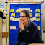 Smile Maker Joan Johnson observes the classroom as the Delta Dental of Washington Tooth Fairy reveals she has a special surprise. COURTESY, VanHouten Photography