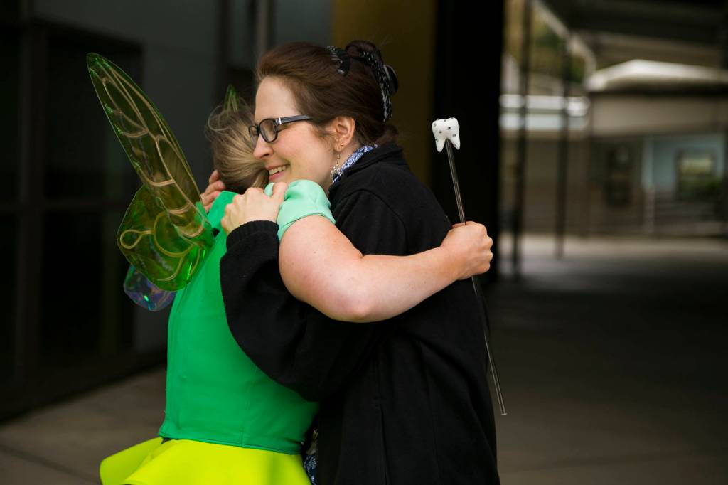 Smile Maker Joan Johnson hugs the Delta Dental of Washington Tooth Fairy to show her appreciation. COURTESY, VanHouten Photography