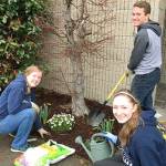 Kelly Tolonen, Belen Elliot and Silas Tuthill, from left to right, plant flowers donated by Kent East Hill Nursery and McLendon&rsquo;s Hardware on April 1 at the Kent Post Office on the East Hill.