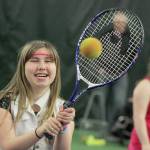 Arianna Conley, 14, breaks into a smile during net play at camp at the Boeing Employees Tennis Center last Saturday. MARK KLAAS, Kent Reporter