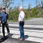 Gov. Jay Inslee, left, BNSF Railway spokesman Gus Melonas and state Utilities and Transportation Commission Chairman David Danner discuss improvements to the railroad crossing near Butler Loop Road in Skamania County during a visit Tuesday by Inslee to the crossing.