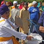 Combatants spar in a demonstration during the Khalsa Day parade through the streets of Kent on Sunday. MARK KLAAS, Kent Reporter
