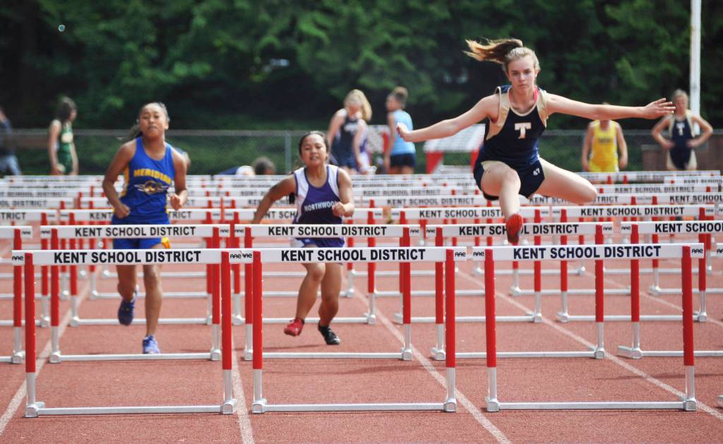 Natasha Verhelst, of Tahoma Blue, soars over a hurdle, as Northwood&rsquo;s Catherine Garcia and Meridian&rsquo;s Kianna Valdez approach a hurdle. HEIDI SANDERS, Kent Reporter