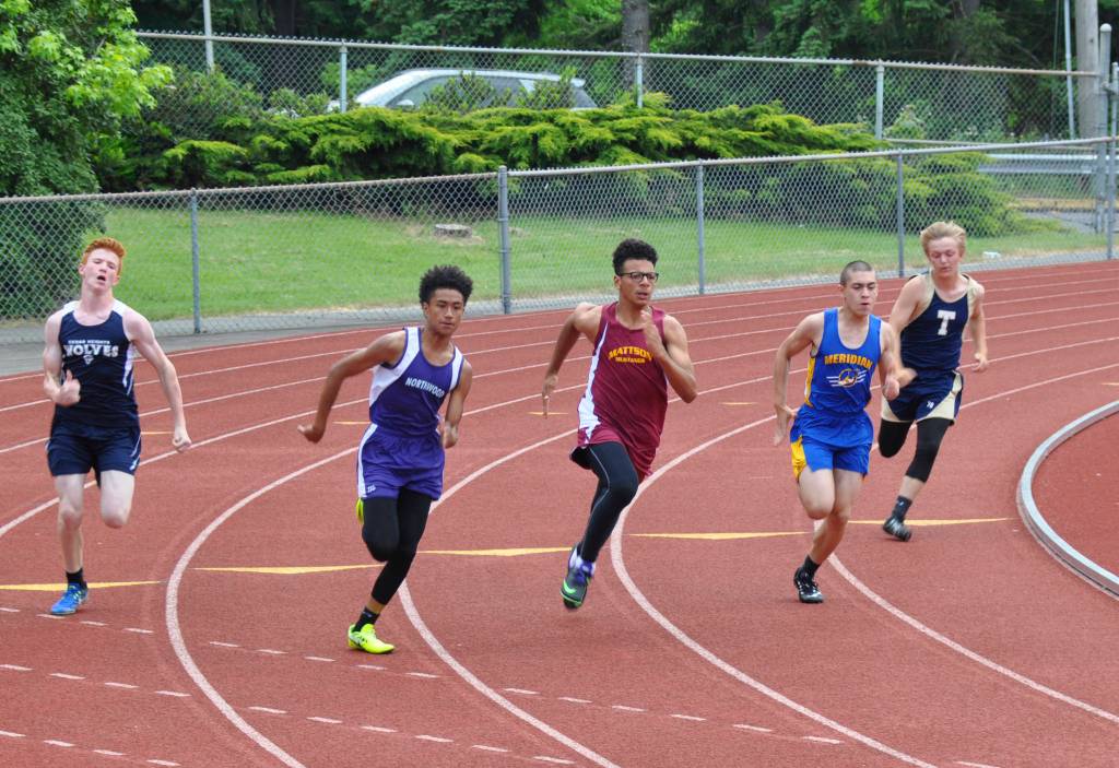 From left, Blake Peterson, Cedar Heights; Benjamin Wellington, Northwood; Sean Hicks, Mattson; Phillip Roush, Meridian; and Christopher Wagner, Tahoma Blue, round the curve in the boys 200 meters. HEIDI SANDERS, Kent Reporter