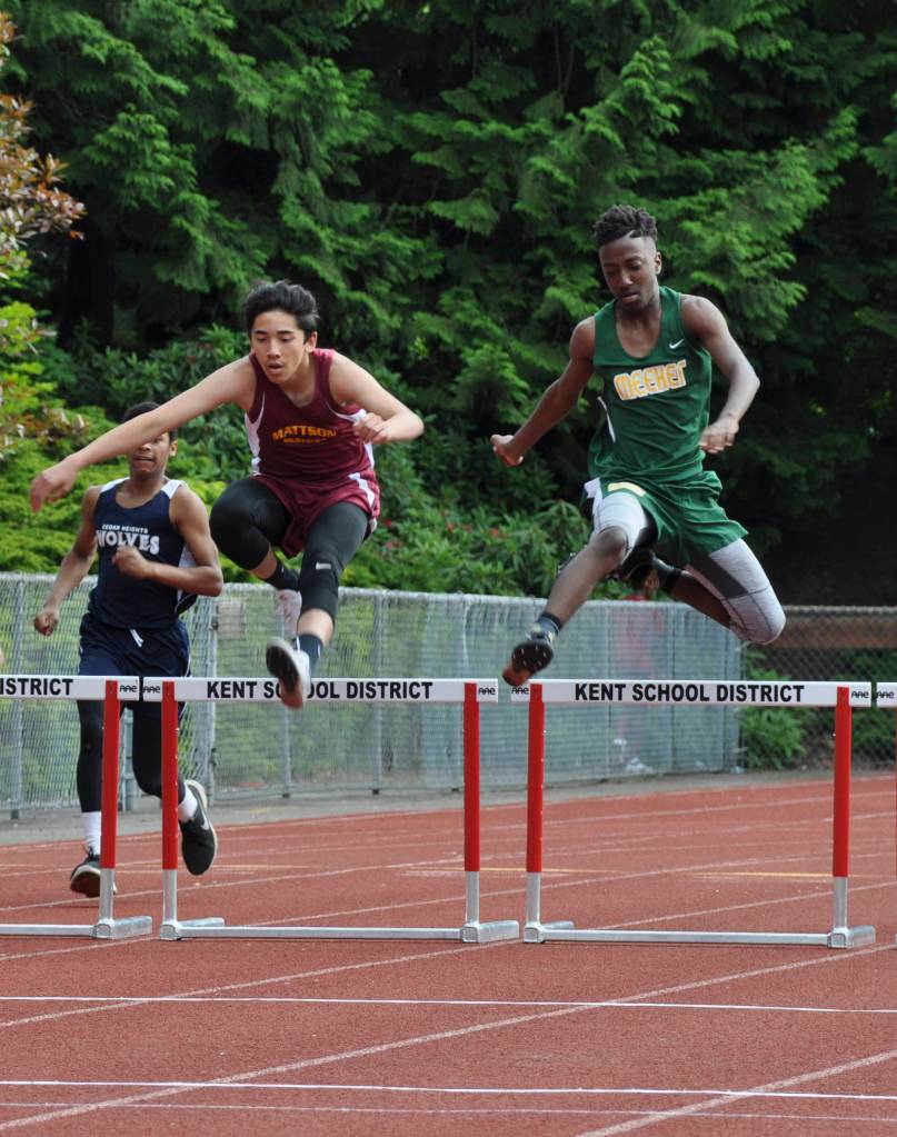 Mattson&rsquo;s Andrew Espinoza, left, and Meeker&rsquo;s Keshawn Douglas jump hurdles in the boys 200-meter hurdles. HEIDI SANDERS, Kent Reporter