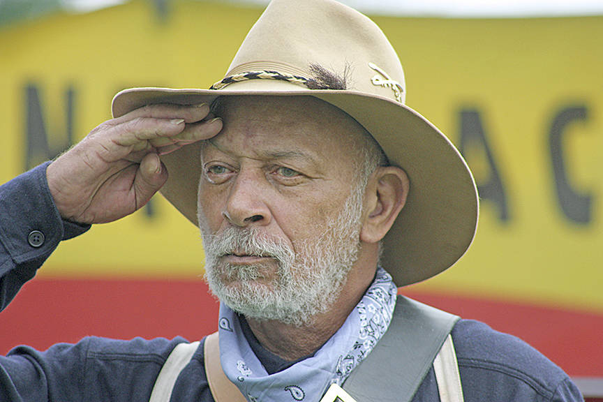 Leonard Howze, of the Buffalo Soldiers of Seattle, salutes during opening ceremonies. MARK KLAAS, Kent Reporter