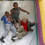 Children sail down a slide. MARK KLAAS, Kent Reporter