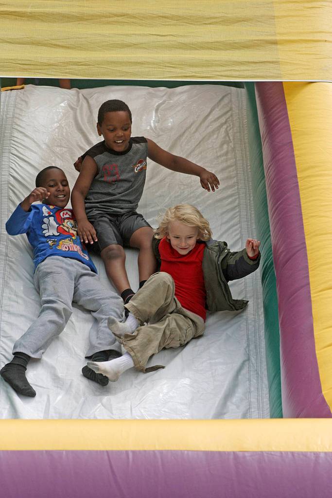 Children sail down a slide. MARK KLAAS, Kent Reporter