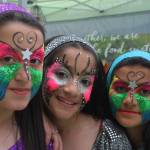 Freshly face-painted Amneea Idrahim, left, Rafal Flayyih, middle, and Zahraa Mohammed enjoy the celebration the festivities in the plaza on Saturday. MARK KLAAS, Kent Reporter