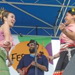 Natthanik Hall, left, and Wachiraphon McArdle, of Siam Smile Dance, a Thai classical and folk performance group, entertains on the Plaza Stage at the Kent International Festival on Saturday. MARK KLAAS, Kent Reporter