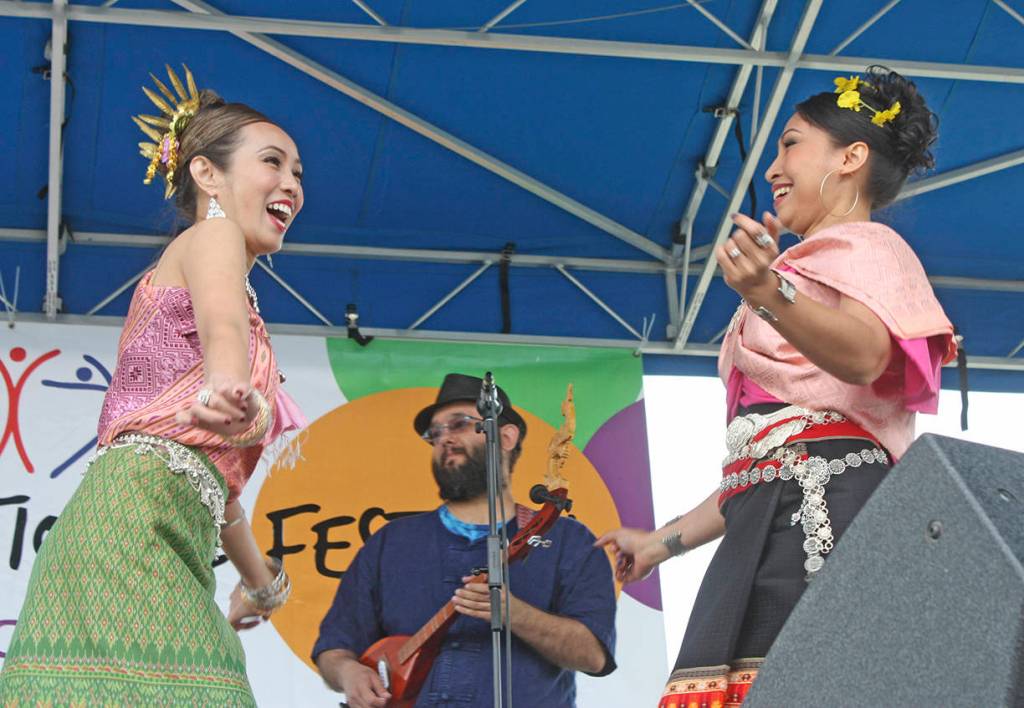 Natthanik Hall, left, and Wachiraphon McArdle, of Siam Smile Dance, a Thai classical and folk performance group, entertains on the Plaza Stage at the Kent International Festival on Saturday. MARK KLAAS, Kent Reporter