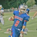Kent-Meridian&rsquo;s Giovonn McDade runs with the ball in a 2013 football game against Jefferson. File Photo/Kent Reporter