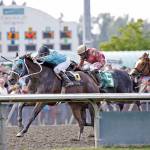 Mach One Rules, ridden by Isaias Enriquez, left, captures the $50,000 Budweiser Stakes for 3-year-olds and up at Emerald Downs on Sunday. COURTESY PHOTO