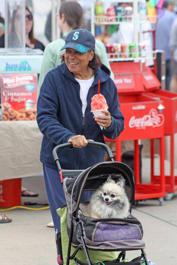 Madeline Hope and her dog, Early, stroll along Second Avenue North in the Town Square Plaza during the opening of the Kent Farmers Market on Saturday. MARK KLAAS, Kent Reporter