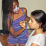 Girls face paint each other at a National Night Out event in 2016 at the Kent Phoenix Academy.